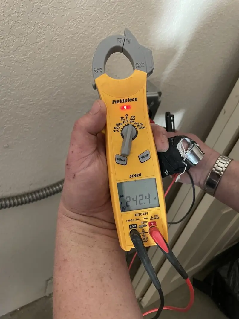 Voltage testing with clamp meter during Recessed Lighting Installation in McCall